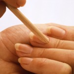Woman removing cuticle