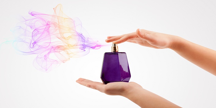 woman hands spraying perfume